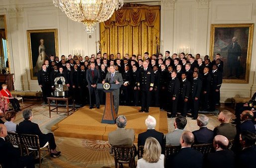 President George W. Bush speaks during the presentation of the Commander-In-Chief Trophy to the U.S. Naval Academy football team in the East Room Monday, April 19, 2004. The trophy is awarded to the Service Academy with the year's best overall record in NCAA football games versus the other academies. White House photo by Tina Hager.