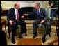 Announcing his intention to nominate him to be the U.S. Ambassador to Iraq, President George W. Bush talks with John Negroponte, who currently serves as the U.S. Ambassador to the United Nations, in the Oval Office Monday, April 19, 2004 White House photo by Eric Draper.