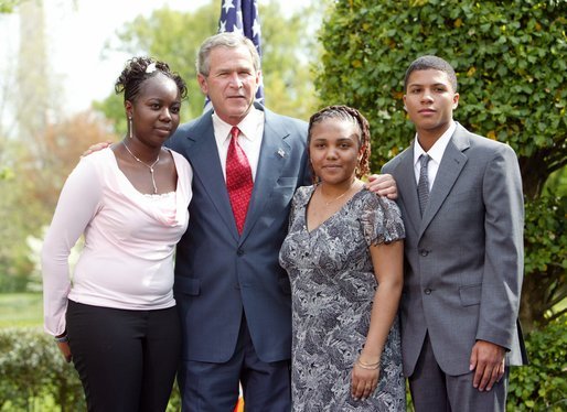 President George W. Bush congratulates the Groundwork Providence Environmental Team of Providence, R.I., on receiving the President’s Environmental Youth Award in the East Garden April 22, 2004. Members of the team include, from left to right, Olabisi Davies, 17, Taja Gonsalves, 15, and Miguel Blanco, 16. White House photo by Susan Sterner.