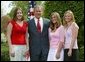 President George W. Bush congratulates, from left to right, Emily Slayton, 19, Jessica Herbrand, 19, and Kristin Fitzer, 19, of the Eatonville High School Salmon Enhancement Group of Eatonville, Wash., on receiving the President’s Environmental Youth Award in the East Garden April 22, 2004. White House photo by Susan Sterner.