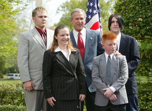 President George W. Bush congratulates the Busy Bison 4-H Club of Barrackville, W.Va., on receiving the President’s Environmental Youth Award in the East Garden April 22, 2004. Members of this club include, from left to right, James Taylor, 15, Katie Ridenour, 16, Cody Gallagher, 9, and Derek Swiger. White House photo by Susan Sterner.