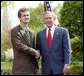 President George W. Bush congratulates Andrew Rominger, 17, of Albuquerque, N.M., on receiving the President’s Environmental Youth Award in the East Garden April 22, 2004. White House photo by Susan Sterner.