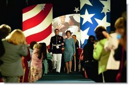 Laura Bush is escorted into the Congressional Club First Ladies Spouses Luncheon as the honored guest at the Washington Hilton in Washington, D.C., April 22, 2004.  White House photo by Tina Hager