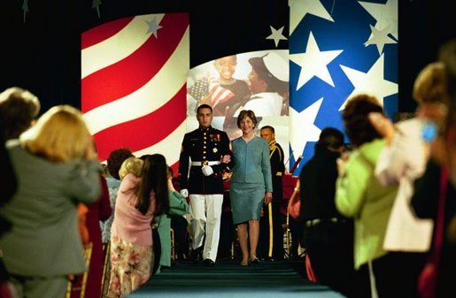 Laura Bush is escorted into the Congressional Club First Ladies Spouses Luncheon as the honored guest at the Washington Hilton in Washington, D.C., April 22, 2004. White House photo by Tina Hager