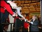 President George W. Bush greets the crowd after giving remarks to the American Associations of Community Colleges annual convention in Minneapolis, Minn., Monday, April 26, 2004. White House photo by Paul Morse.