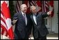 President George W. Bush and Canadian Prime Minister Paul Martin respond to questions from the press corps in the Rose Garden after a meeting at the White House on April 30, 2004. White House photo by Paul Morse