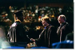 Laura Bush congratulates a graduate from the Class of 2004 of Miami Dade College in Miami, Fla., Saturday, May 1, 2004.  White House photo by Tina Hager