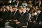 President George W. Bush and Laura Bush bow their heads in prayers during a White House ceremony honoring Cinco de Mayo in the East room Wednesday, May 5, 2004. "Mexican Americans have brought many strengths to our nation: a culture built around faith in God, a deep love for family, a belief that hard work leads to a better life," said the President in his remarks. "Every immigrant who lives by these values makes our country better and makes our future brighter." White House photo by Paul Morse