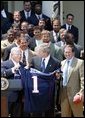 President George W. Bush receives a jersey from New England Patriots owner Bob Kraft and coach Bill Belichick during a photo opportunity with the Super Bowl champions in the Rose Garden on May 10, 2004. White House photo by Paul Morse