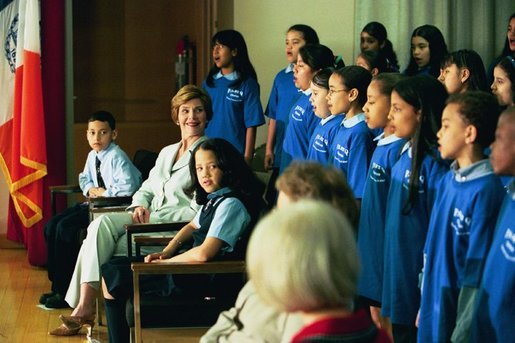 Laura Bush listens to the choir of the P.S. 92 Harry T. Stewart School in Corona, N.Y., during a grant presentation by the Laura Bush Foundation for America's Libraries Monday, May 10, 2004. White House photo by Tina Hager