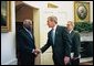 President George W. Bush welcomes President Jose Eduardo dos Santos of Angola to the Oval Office Wednesday, May 12, 2004. White House photo by Eric Draper