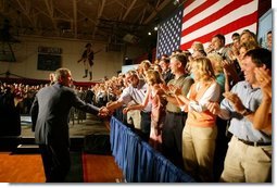 President George W. Bush greets the audience before participating in a conversation on High School Initiatives at Parkersburg South High School in Parkersburg, W. Va., Thursday, May 13, 2004.  White House photo by Paul Morse