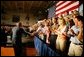 President George W. Bush greets the audience before participating in a conversation on High School Initiatives at Parkersburg South High School in Parkersburg, W. Va., Thursday, May 13, 2004. White House photo by Paul Morse