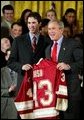 President George W. Bush stands with Ryan Caldwell of the University of Denver men's hockey team during a ceremony in the East Room congratulating four NCAA teams for winning national titles Wednesday, May 19, 2004. White House photo by Paul Morse.