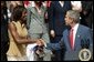 President George W. Bush greets Detroit Shock player Swin Cash during a photo opportunity with the 2003 WNBA champions in the Rose Garden on May 24, 2004. White House photo by Paul Morse.