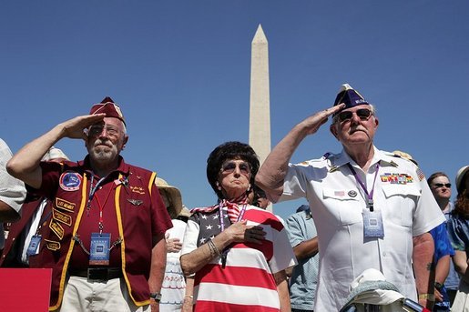 People attending the dedication of the World War II Memorial salute on the Mall in Washington, DC on May 30, 2004. White House photo by Paul Morse