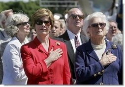 Laura Bush and Former First Lady Barbara Bush stand during the National Anthem at the National World War II Memorial on the National Mall, Saturday, May 29, 2004. White House photo by Eric Draper