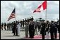 Hosted by Deputy U.S. Chief of Protocol Jeff Eubank, far right, Canadian Prime Minister Paul Martin and his wife Sheila Martin participate in an arrival ceremony at Hunter Army Airfield Tuesday, June 8, 2004. White House photo by Paul Morse