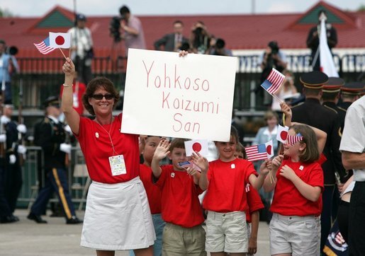 Children cheer the arrival of Japanese Prime Minister Junichiro Koizumi at Hunter Army Airfield in Savannah, Ga., June 8, 2004. White House photo by Paul Morse