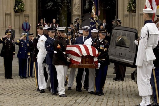 The casket of former President Ronald Reagan is loaded into a hearse at the funeral service at the National Cathedral in Washington, DC on June 11, 2004. White House photo by Paul Morse.