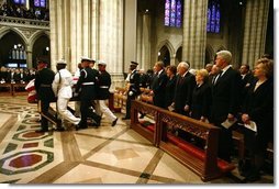 President George W. Bush and Laura Bush, Vice President Dick Cheney and Lynne Cheney, along with four former US Presidents, and other world dignitaries watch as the casket of former President Ronald Reagan is carried into the National Cathedral in Washington, D.C., Friday, June 11, 2004.  White House photo by David Bohrer