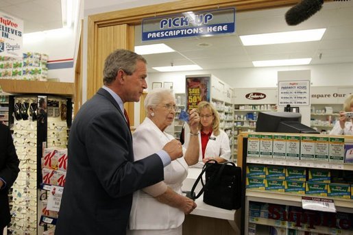 President George W. Bush helps senior Wanda Blackmore buy her prescriptions with her new drug discount card at the Hy-Vee pharmacy in Liberty, Mo., June 14, 2004. White House photo by Paul Morse