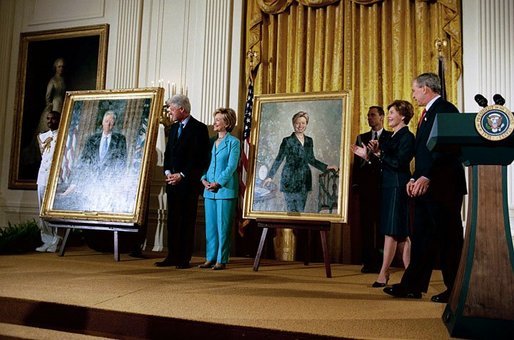 President George W. Bush and Laura Bush host the unveiling of the Clinton portraits as former President Bill Clinton and Senator Hillary Clinton stand by their official White House portraits in the East Room of the White House Monday, June 14, 2004. White House photo by Paul Morse