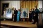 President George W. Bush and Laura Bush host the unveiling of the Clinton portraits as former President Bill Clinton and Senator Hillary Clinton stand by their official White House portraits in the East Room of the White House Monday, June 14, 2004. White House photo by Paul Morse