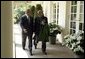 President George W. Bush and Hamid Karzai of Afghanistan walk along the colonnade after holding a joint press conference in the Rose Garden Tuesday, June 15, 2004. White House photo by Paul Morse.