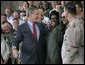 President George W. Bush greets stage participants after delivering remarks to military personnel at MacDill Air Force Base in Tampa, Florida, Wednesday, June 16, 2004. White House photo by Eric Draper.