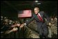 President George W. Bush greets Fort Lewis military personnel in the audience during his introduction at Fort Lewis, Washington, Friday, June 18, 2004. White House photo by Eric Draper.