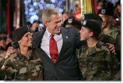 President George W. Bush joins soldiers on stage following his remarks at Fort Lewis, Washington, Friday, June 18, 2004.  White House photo by Eric Draper