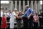 President George W. Bush greets the crowd at the Fourth of July Celebration on the steps of the Capitol in Charleston, West Virginia on Independence day, 2004. White House photo by Tina Hager