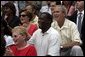 President George W. Bush and First Lady Laura Bush watch the Challenger Phillies of M.O.T. Little League from Middletown, Delaware take on the Challenger Yankees of Lancaster County Little Leagues from Lancaster County, Pennsylvania with former NFL Washington Redskins player Darrell Green, center, at Tee Ball on the South Lawn at the White House on Sunday July 11, 2004. White House photo by Paul Morse.