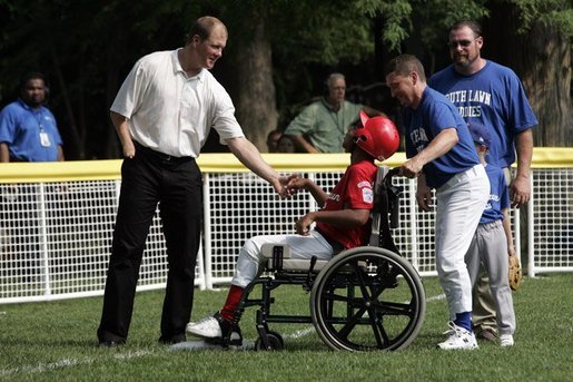 Former Major League pitcher Jim Abbott congratulates a player from the Challenger Phillies from Middletown, Delaware at Tee Ball on the South Lawn at the White House on Sunday July 11, 2004. White House photo by Paul Morse.