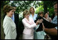 Laura Bush and Ana Ligia Mixco Sol de Saca, wife of President Antonio Saca of El Salvador, greet Barney, the Bush family's dog, after having coffee at the White House Tuesday, July 13, 2004. White House photo by Joyce Naltchayan