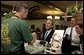 President George W. Bush chats with Ray Cuttle the owner of the La Tropicana Café in Ybor City, Florida on Friday July 16, 2004. White House photo by Paul Morse