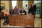 President George W. Bush signs an executive order for individuals with disabilities in emergency preparedness Thursday, July 22, 2004 in the Oval Office. White House photo by Eric Draper.