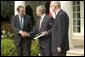 Accompanied by Chairman Thomas Kean, left, and Vice Chairman Lee Hamilton of the 911 Commission, President George W. Bush addresses the press during the presentation of the Commission's report in the Rose Garden Thursday, July 22, 2004. White House photo by Eric Draper.