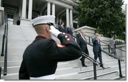 President George W. Bush walks downs the steps of the Dwight D. Eisenhower Executive Office Building with Defense Secretary Donald Rumsfeld after signing H.R.4613.  White House photo by Eric Draper