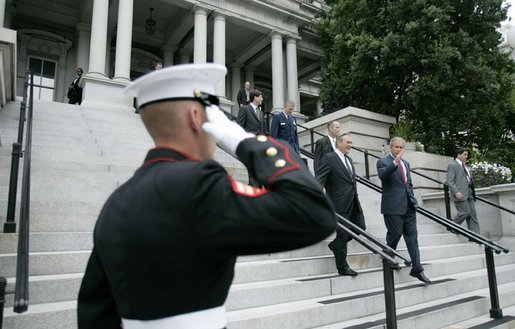 President George W. Bush walks downs the steps of the Dwight D. Eisenhower Executive Office Building with Defense Secretary Donald Rumsfeld after signing H.R.4613. White House photo by Eric Draper