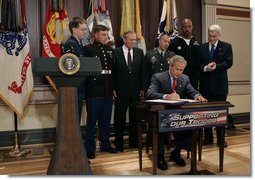 President George W. Bush signs H.R.4613, The Defense Appropriations Act for Fiscal Year 2005, in the Dwight D. Eisenhower Executive Office Building Thursday, Aug. 5, 2004.   White House photo by Eric Draper