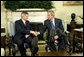 President George W. Bush and Prime Minister Marek Belka of Poland meet with the press in the Oval Office Monday, Aug. 9, 2004. White House photo by Eric Draper