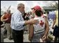 President George W. Bush talks to an American Red Cross worker while touring relief efforts in response to Hurricane Frances damage in Ft. Pierce, Fla., Wednesday, Sept. 8, 2004. White House photo by Eric Draper