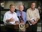 President George W. Bush delivers a live statement to Floridians affected by Hurricane Frances at the National Hurricane Center in Miami, Fla., Wednesday, Sept. 8, 2004. Also pictured from left are Max Mayfield Director of the National Hurricane Center and Florida Gov. Jeb Bush. White House photo by Eric Draper