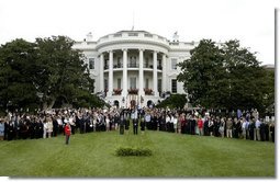 President George W. Bush, Mrs. Bush, Vice President Dick Cheney and Mrs. Cheney, center, are joined by White House staff and families of victims of 911 for a Moment of Silence on the South Lawn at 8:46am, Saturday, Sept. 11, 2004.  White House photo by Tina Hager