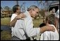 President George W. Bush comforts residents during a walking tour of neighborhoods damaged by Hurricane Ivan in Pensacola, Florida, Sunday, Sept. 19, 2004. White House photo by Eric Draper