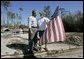 President George W. Bush talks with resident Jim Heinold during a walking tour of neighborhoods damaged by Hurricane Ivan in Pensacola, Florida, Sunday, Sept. 19, 2004 White House photo by Eric Draper