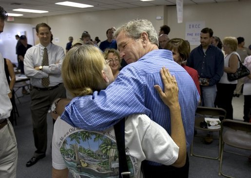 President George W. Bush shares a hug during a visit to Martin County Red Cross Headquarters in Stuart, Fla., Thursday, Sept. 30, 2004. "People in Florida and many other states are coming through a trying time," said the President in an address to the press. "I thank all those who've reached out to help the neighbors in need." White House photo by Eric Draper