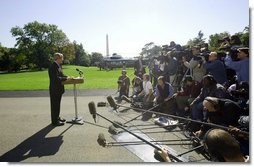 President George W. Bush discusses the Iraq report with the press on the South Lawn Thursday, Oct. 7, 2004.  White House photo by Eric Draper